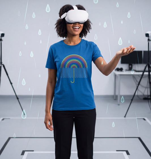 Young woman in Royal Blue Surrealism Rain t-shirt wearing a VR headset and catching virtual raindrops in a VR test lab